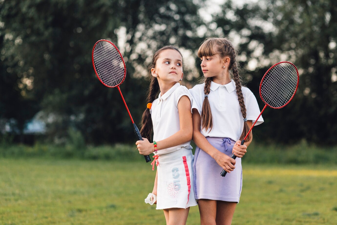 angry-girls-holding-badminton-hand-looking-each-other_23-2147904853