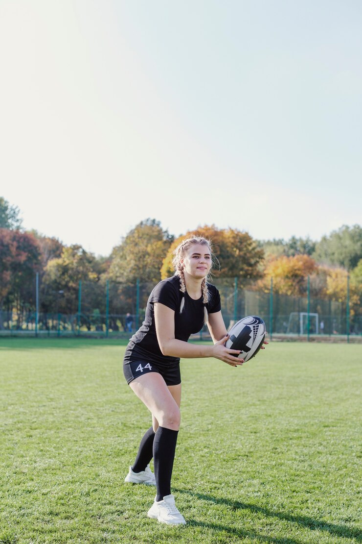 beautiful-blonde-girl-catching-rugby-ball_23-2148355418